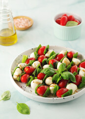 A plate with Italian salad caprese canape