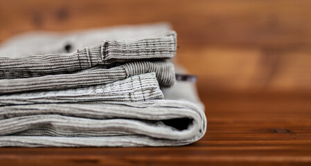 Folded corduroy trousers on the table. Cord material pants banner.