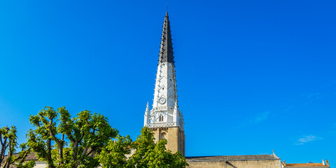 Saint Etienne church and its black and white bell tower in Ars-en-Ré, France