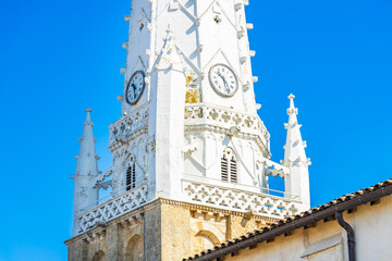 Close up on the bell tower and the clocks of Saint-Etienne church in Ars-en-Ré, France
