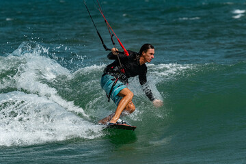 Fototapeta premium A kite surfer rides the waves