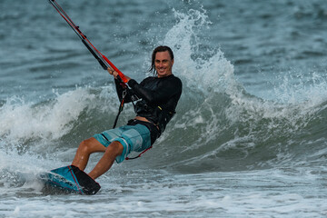 Fototapeta premium A kite surfer rides the waves