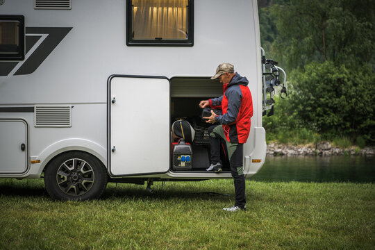 Man Leaving RV Park Campground and Checking His Motorhome Storage
