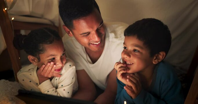 Funny, tablet and father with children in a tent house streaming internet video, show or movie online in the night. Dark, digital and parent or dad relax with kids watching comedy in the evening