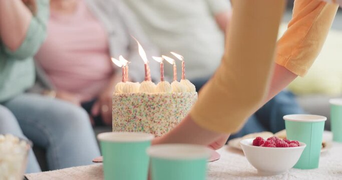 Celebration, family and person with a cake for a birthday, party or surprise in a house. Carrying, candles and hands of a child giving sweet food or dessert on a table for people to celebrate