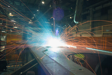 Welding Sparks  from robot  in manufacturing with blur focus, used is background