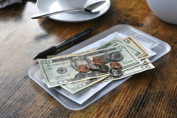 Paying for your bill tab at a restaurant cafe with cash money. - obrazy, fototapety, plakaty