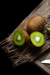 kiwi fruit on wood table background with dark rustic moody theme taken from top view angle