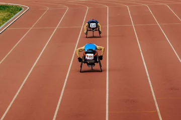 Photo sur Plexiglas Chemin de fer two athletes in wheelchair racing race track stadium in para athletics championship, summer sports games