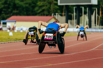 group athletes in wheelchair racing race track stadium in para athletics championship, summer...