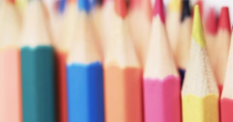 Close up of sharpened multi coloured pencils with copy space on white background