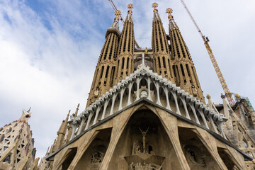Front entrance at La Sagrada Familia church by Antoni Gaudi in Barcelona. It is one of the longest...