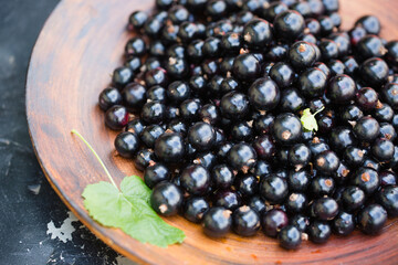 black currants in a wooden bowl