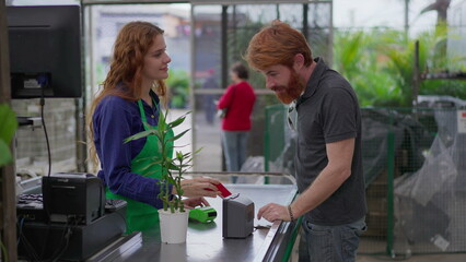 Customer buying a Plant using contactless payment with phone at Horticulture Store Checkout