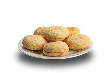 Pile of delicious homemade small round cake filled with pineapple jam in white ceramic plate isolated on white background with clipping path.