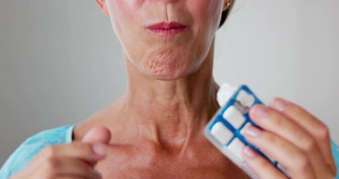 Woman Using Nicotine Gum To Quit Smoking