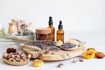 Tuinposter Botanical blends, herbs, essencial oils for naturopathy. Natural remedy, herbal medicine, blends for bath and tea on wooden table background © netrun78