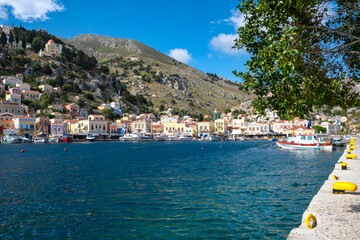 Fototapeta premium A Beautiful View of the Colorful Houses in the Harbor of Symi