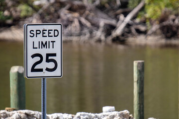 25 MPH Speed Limit sign by the water