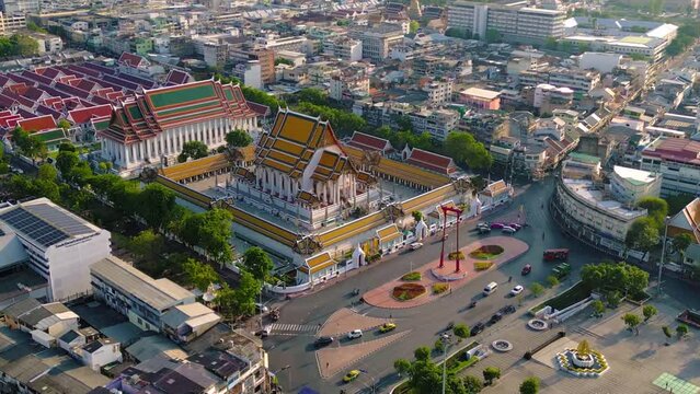 Aerial top view of Giant Swing or Sao Ching Cha monument with Wat Suthat temple at sunset in old town, Bangkok City, Thailand. Landmark tourist attraction. Thai architecture with travel trip concept.