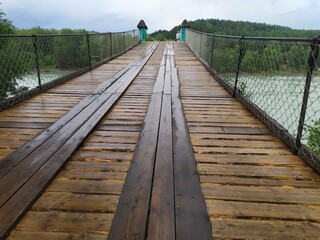 A beautiful old wooden bridge over the fast river