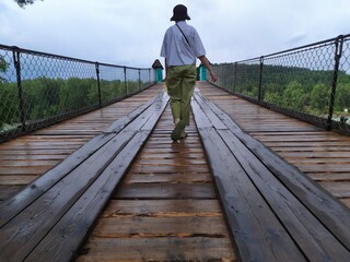 A girl in a hat walks across the bride