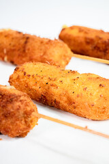 Fried Corn Dog Stacked Up on a Plate
