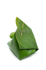 Thai dessert - wrapped in banana leaves with small bamboo wood stick -path