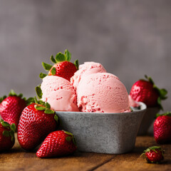 Strawberry ice cream in a bowl, with fresh fruit