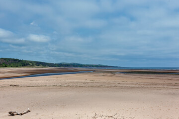 The exposed sandy beach at low tide at the mouth of the River North Esk on the northern point of Montrose Beach, opposite St Cyrus.