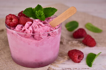 A glass of homemade raspberry ice cream and fresh raspberries.Close-up.
