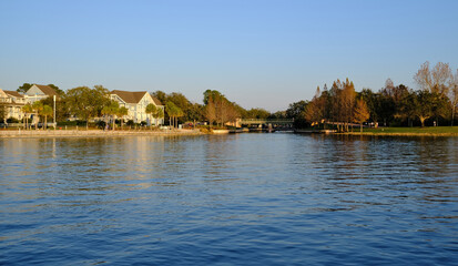 Fototapeta premium Golden hour sunset over lake with buildings being reflected in the background in winter Florida 