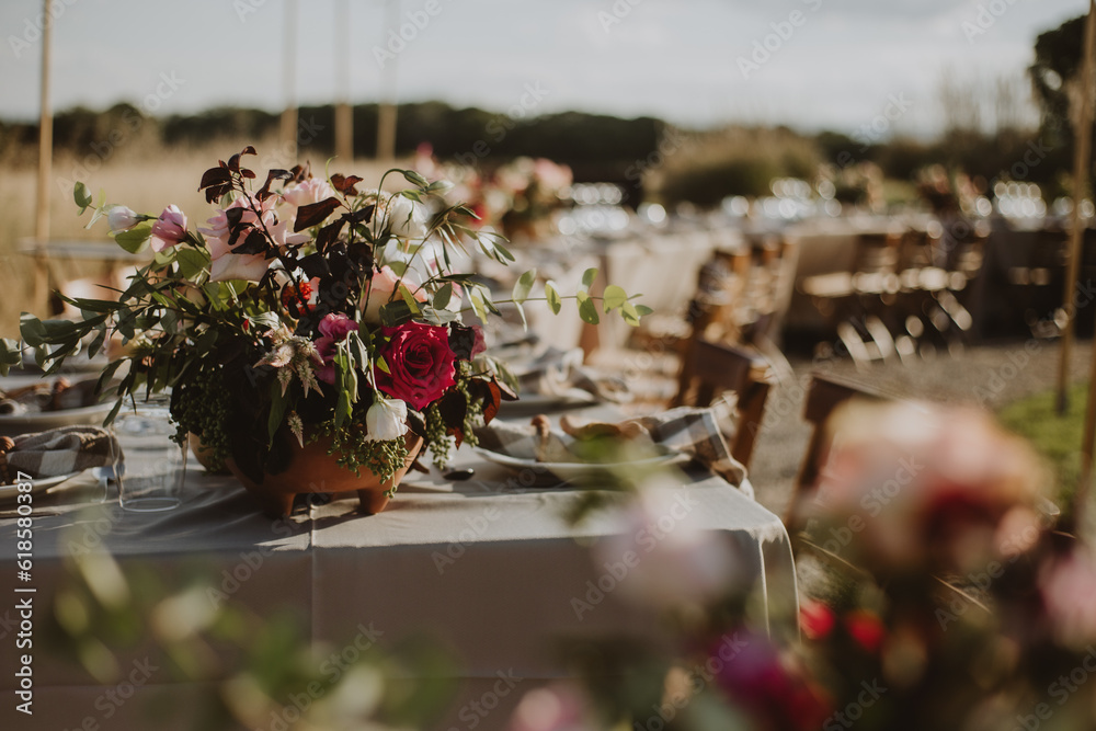 Wall mural outdoor wedding decoration. table setting with flowers.