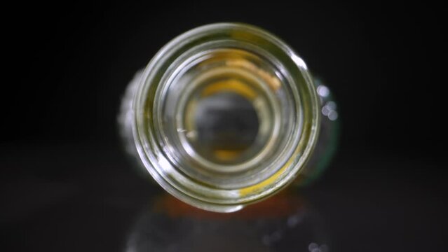 The neck of an empty bottle for cognac close-up. Dolly shot