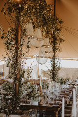 table setting with cup of wine, candles and flowers in a wedding