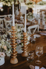 table setting with cup of wine, candles and flowers in a wedding