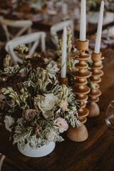 table setting with cup of wine, candles and flowers in a wedding
