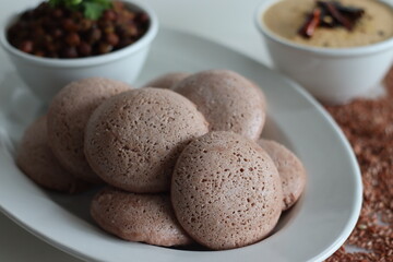 Navara rice idly served black chickpea curry. Steamed savoury rice cake made by a batter of fermented de husked black lentils and navara rice.