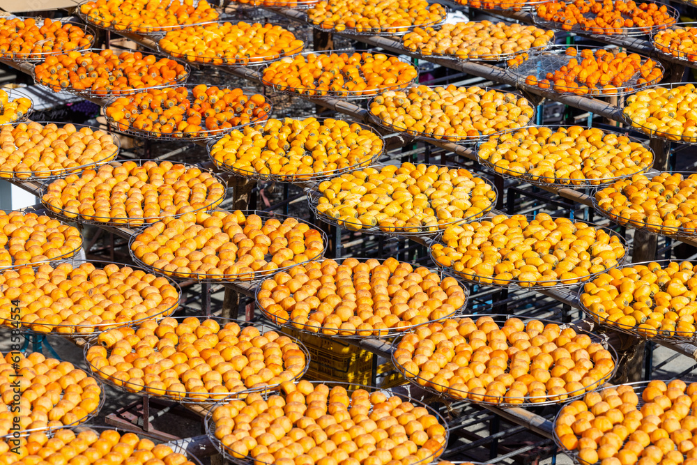 Wall mural Peeled persimmons drying at outdoor