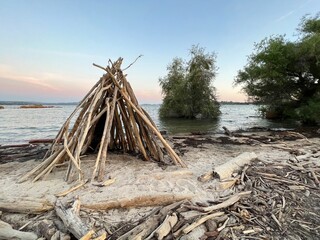 driftwood teepee at sunset