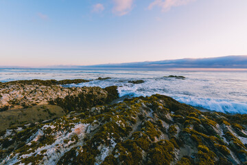 Rocky coastline at low tide at sunset, California