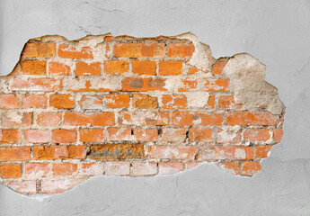 Background of brick wall texture. Crumbling cement plaster in the center. Text space. Close-up.