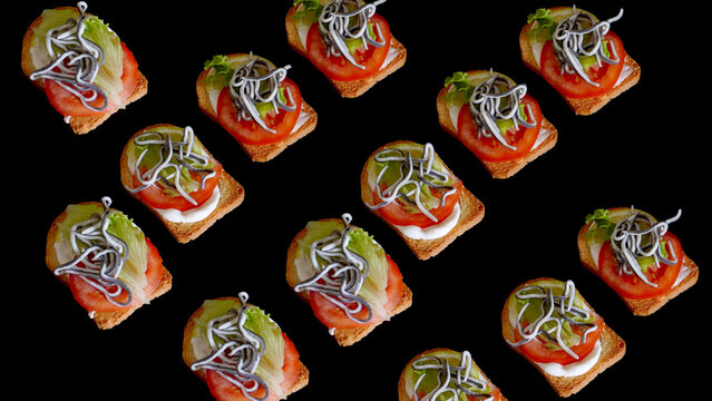  toast with eels, lettuce, mayonnaise and tomato. on a black background    