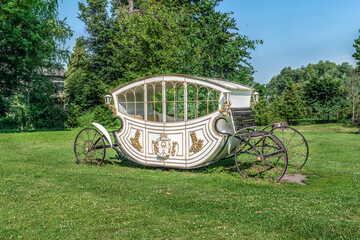 Trostyanets, Sumy Oblast, Ukraine - June 18, 2023: Fairy-tale carriage on a lawn with green grass...