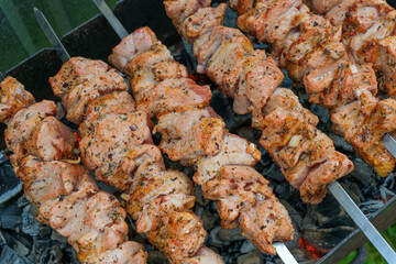Pork skewers, roasted on skewers on the grill. Shashlik meat shish kebab on the grill. traditional outdoor barbecue picnic.