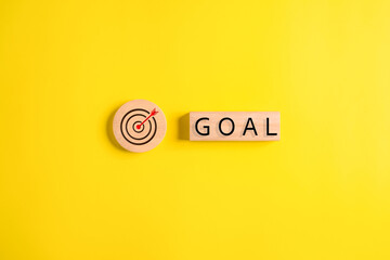 Virtual target board and goal word on wooden blocks, Business achievement goal and objective...