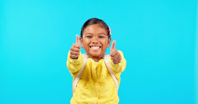 Thank you, girl with thumbs up and against a blue background with portrait for success. Achievement or agreement, approval or winner and young female student with hand emoji gesture for motivation