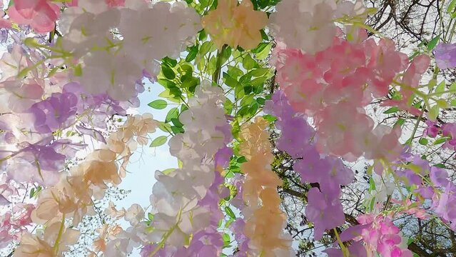 Artificial flowers blossoms.
A bright bouquet of pink Cherry and Sakura blossoms in park.