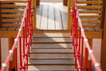 Wooden bridge with strong robe at playground perspective