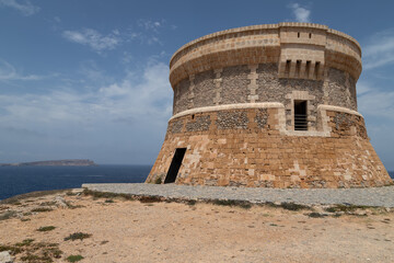 Fototapeta na wymiar 17th century Martello tower on the Spanish island of Menorca near the fishing village of Fornells.